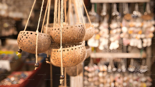 Hanging ceramic pots with a blurred market background