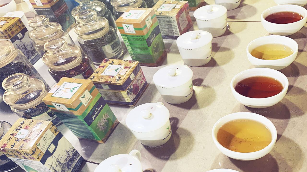 Tea cups and boxes on a table with tea leaves.