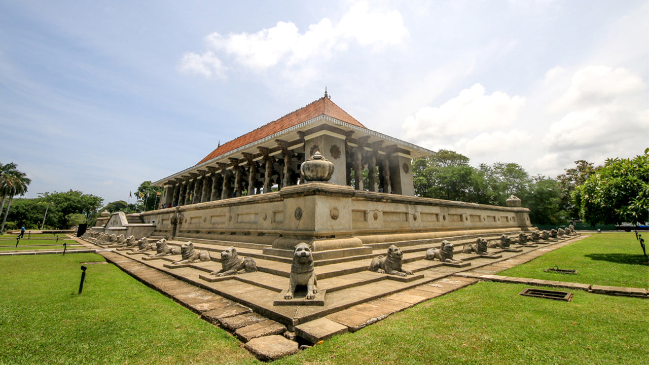 Historic building with steps and statues in a park-like setting